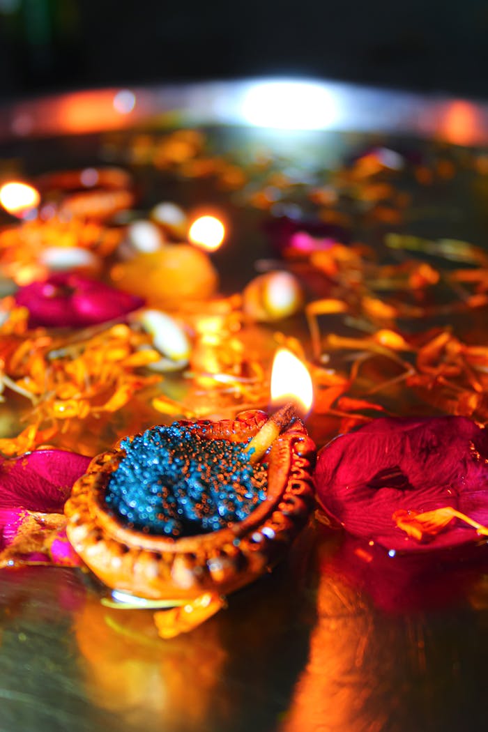 Bright floating diyas and petals in water, perfect for Diwali festive ambiance.